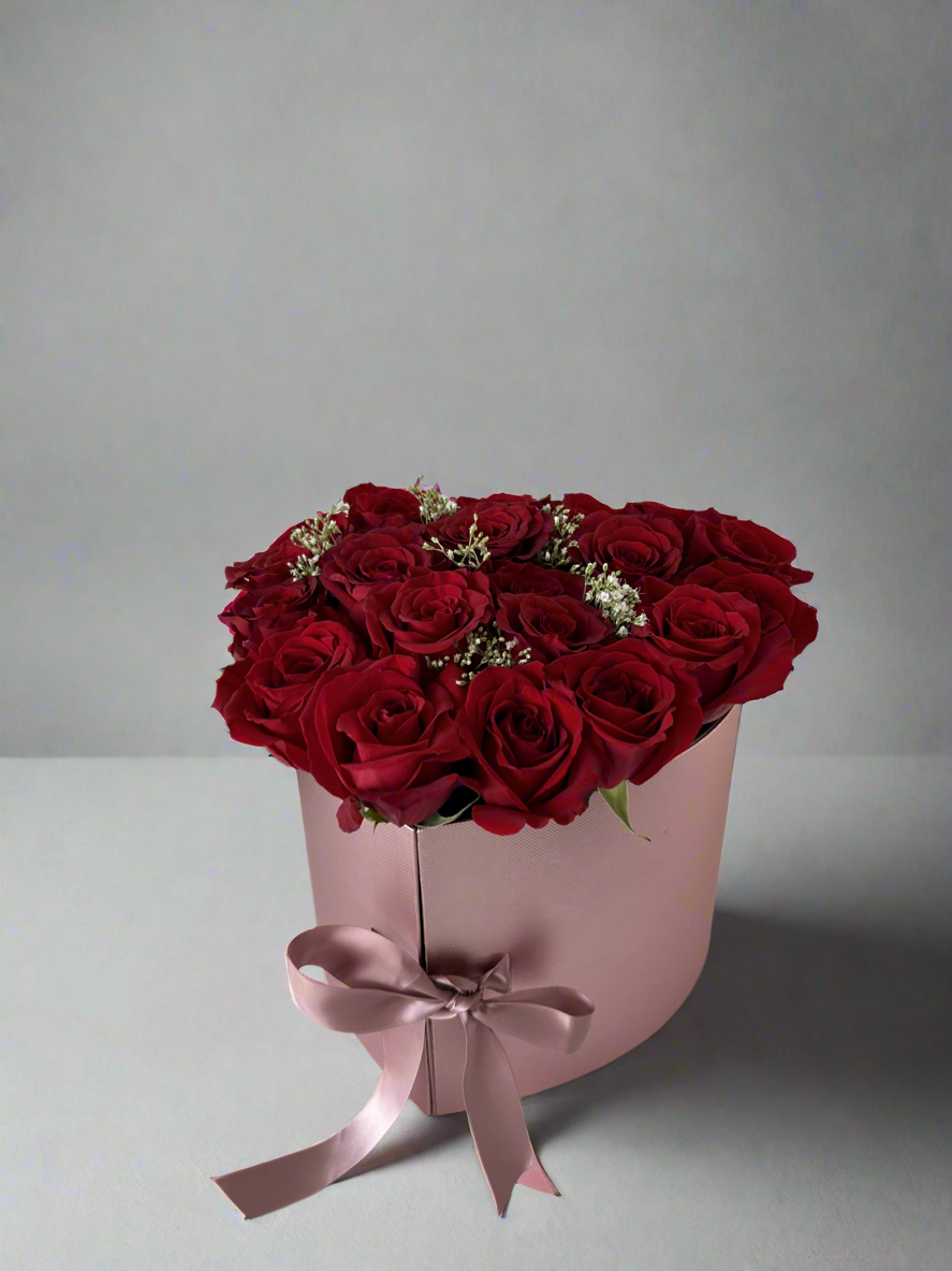 Closed pink box with roses on top