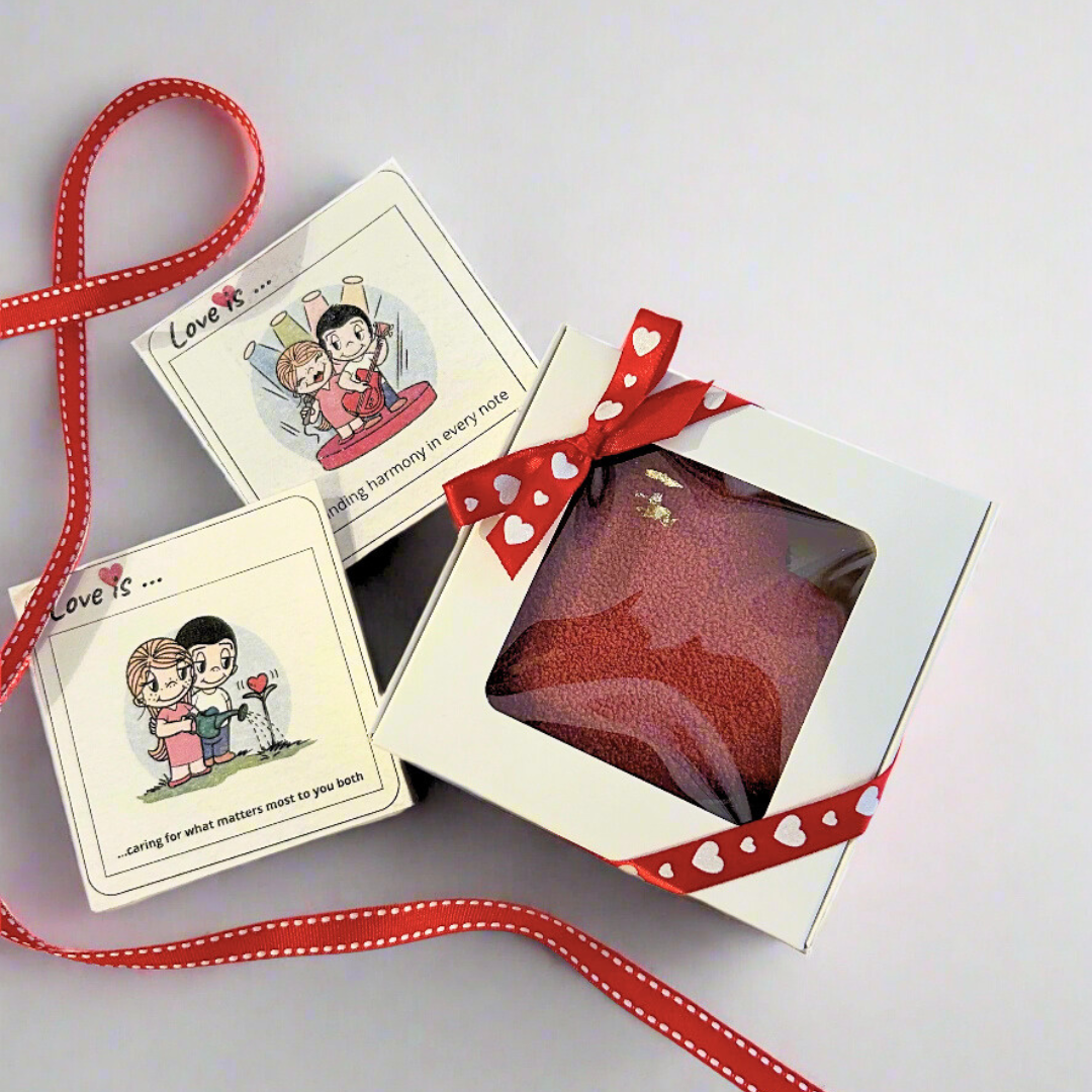 mini heart shaped dessert in white box with ribbons and cards on the background