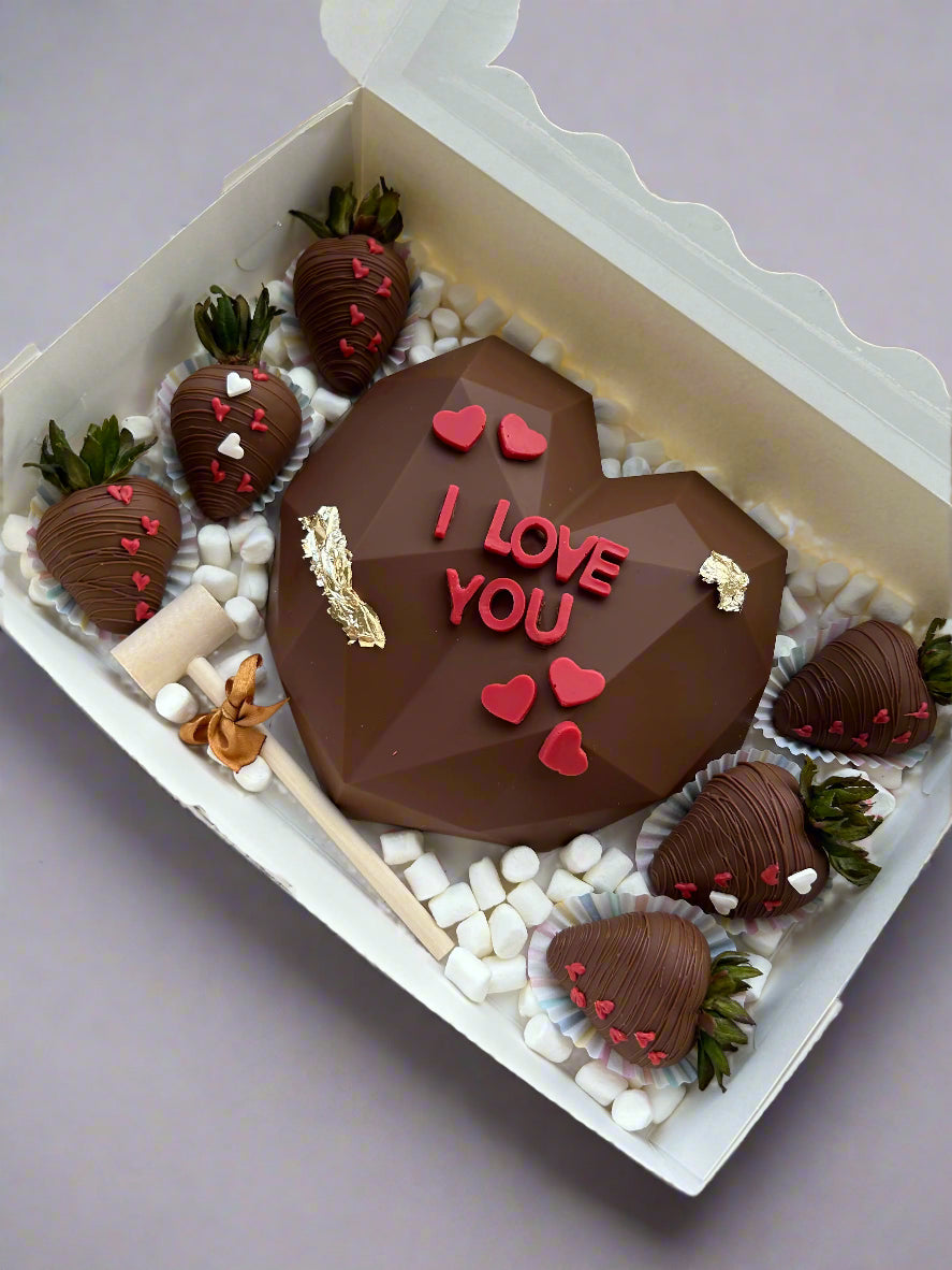 Milk chocolate smash heart with 6 chocolate dipped strawberries in a box with marshmallows