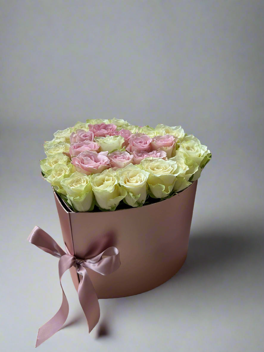 heart shaped box with white and pink roses
