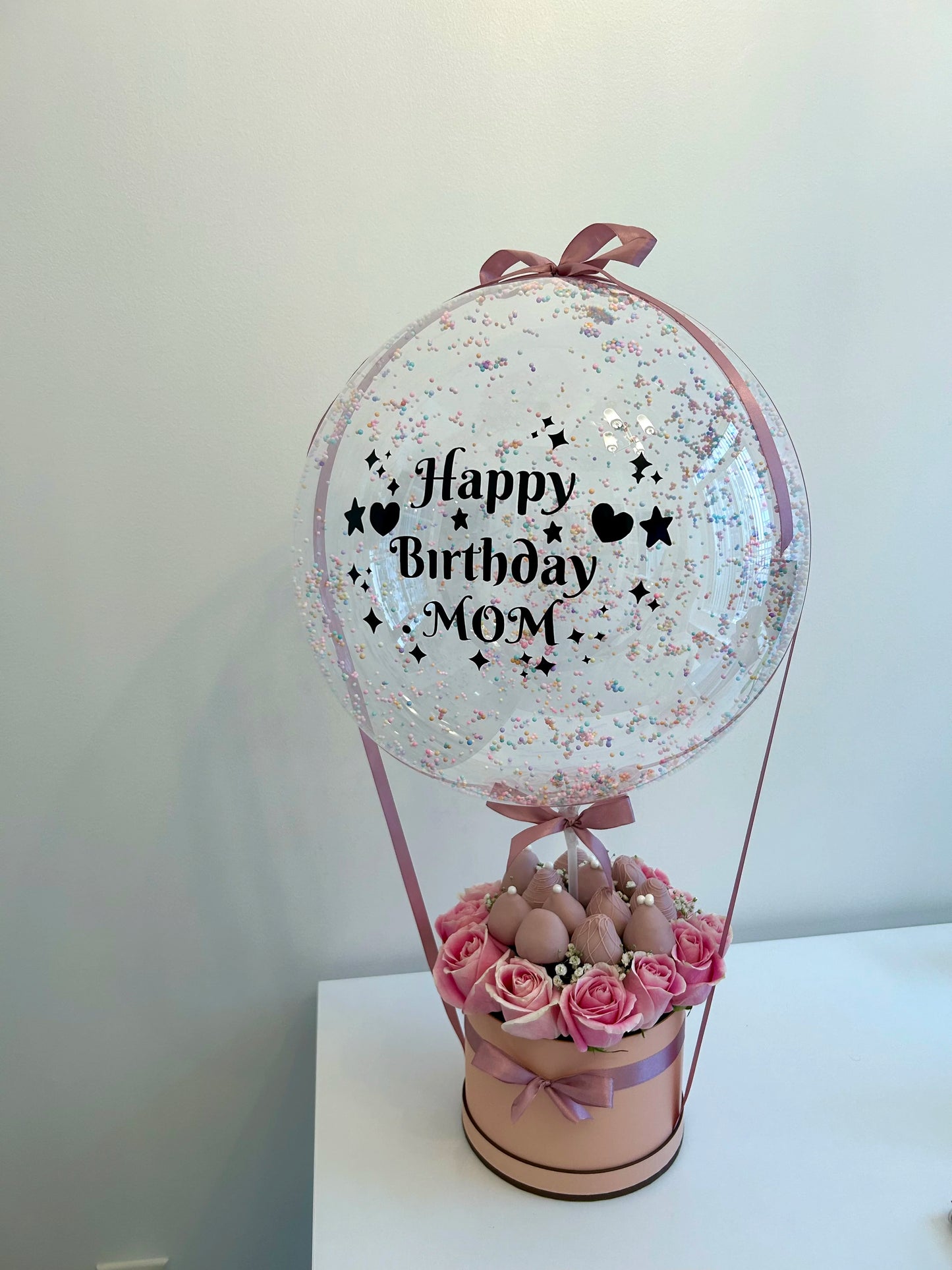 Mother birthday gift with bobo balloon, roses and chocolate-covered strawberries