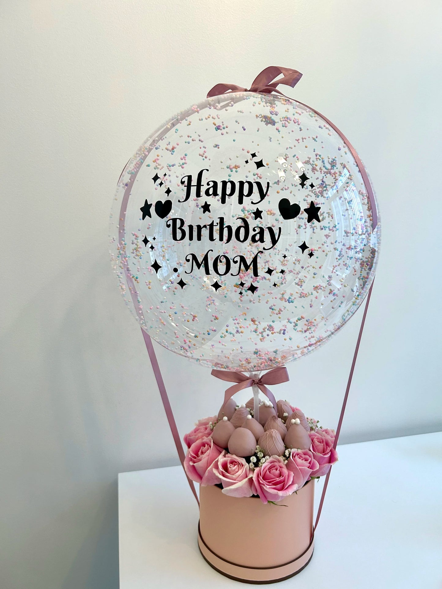 Mother birthday gift with bobo balloon, roses and chocolate-covered strawberries