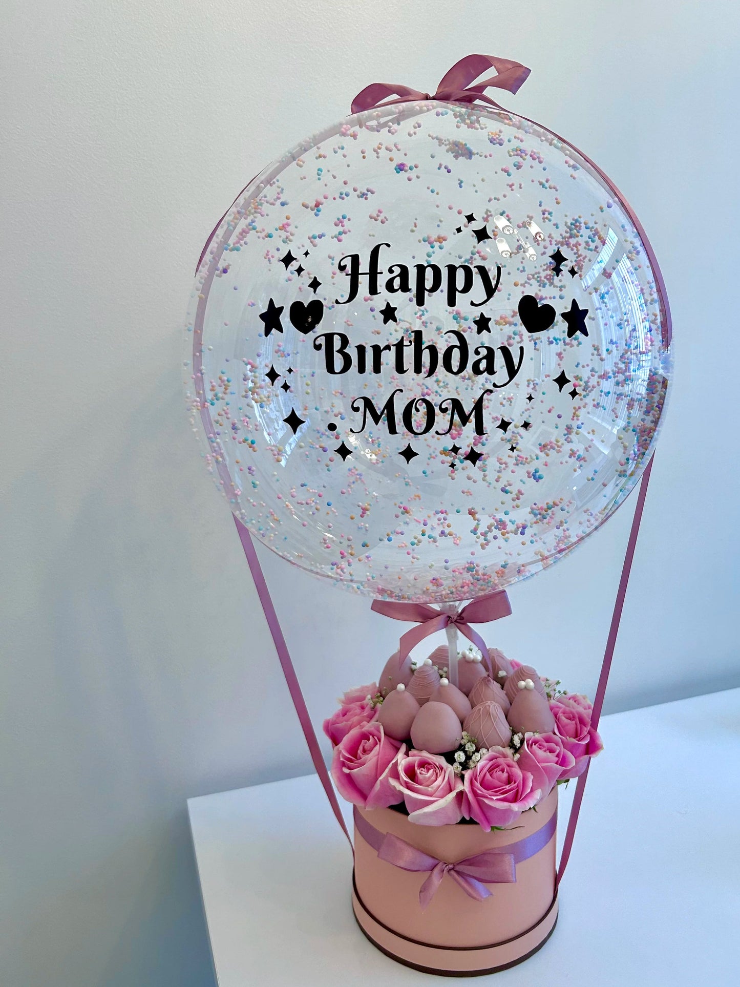 Mother birthday gift with bobo balloon, roses and chocolate-covered strawberries