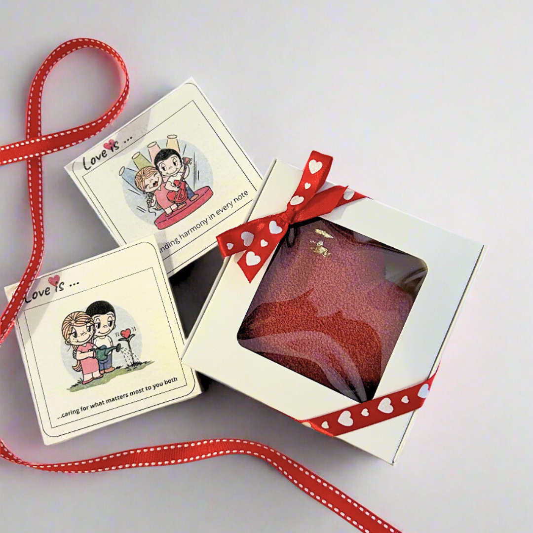 mini heart shaped dessert in white box with ribbons and cards on the background 